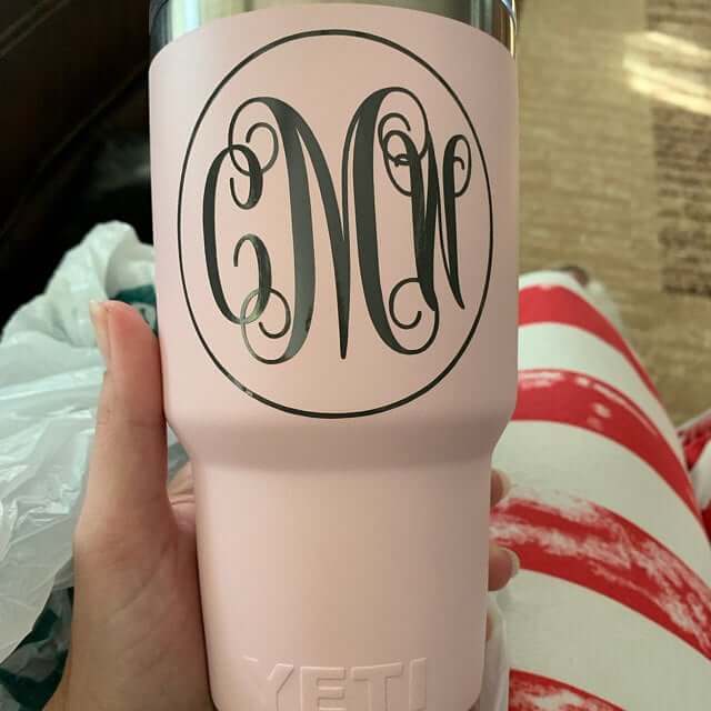 Black vinyl monogram decal on a pink YETI tumbler featuring elegant script initials inside a circular border.